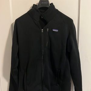 Patagonia, men’s large black jacket. Company branding on arm